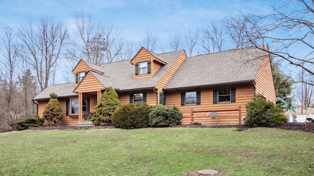 log home with a shingled roof and a front yard