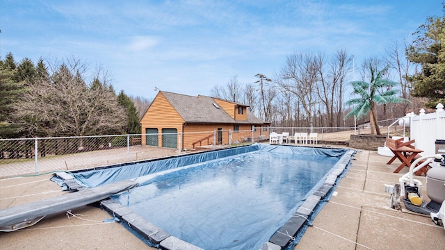 view of swimming pool featuring fence, a fenced in pool, and a patio