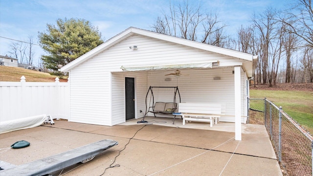 view of outbuilding featuring an outdoor structure and fence