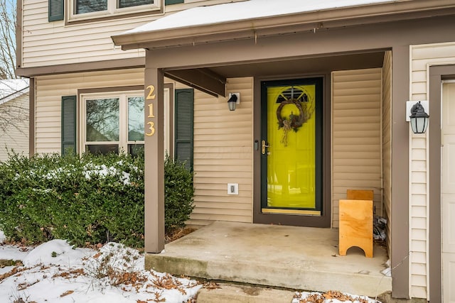 view of snow covered property entrance