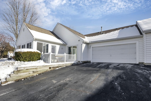 ranch-style home featuring a garage