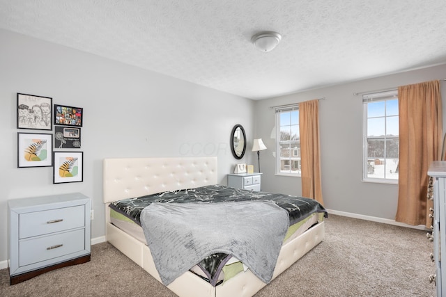 carpeted bedroom featuring a textured ceiling