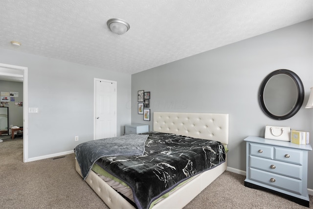 bedroom with a textured ceiling and light carpet