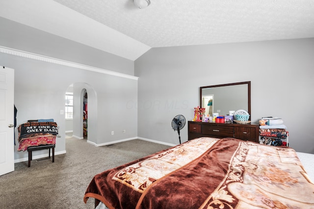 bedroom featuring carpet, a textured ceiling, and vaulted ceiling