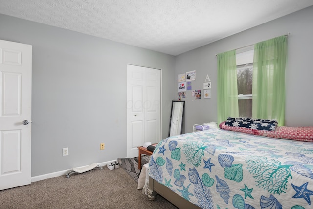 carpeted bedroom with a textured ceiling and a closet