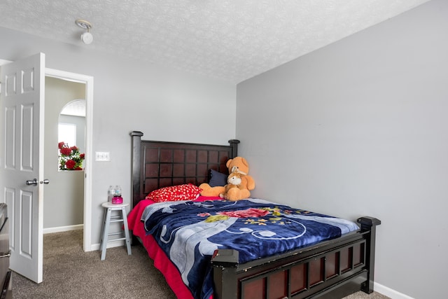 bedroom with carpet floors and a textured ceiling