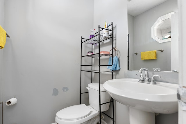 bathroom featuring sink and toilet