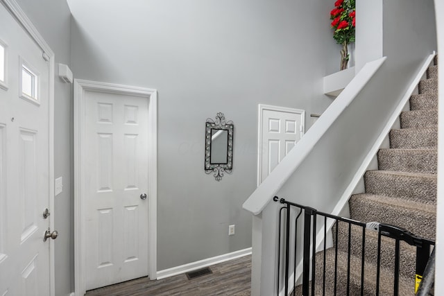 stairs with a high ceiling and hardwood / wood-style flooring