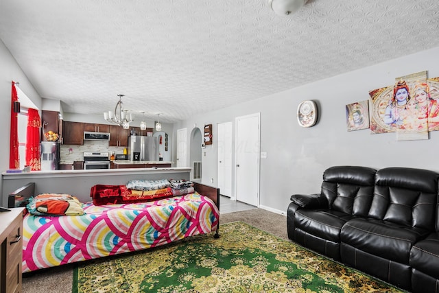 living room with carpet flooring, a textured ceiling, and an inviting chandelier