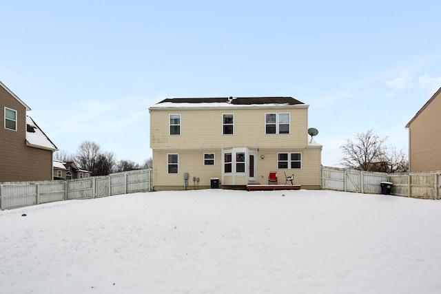 snow covered property with a wooden deck and central AC unit