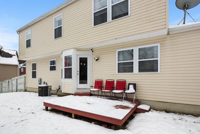 snow covered property featuring central air condition unit