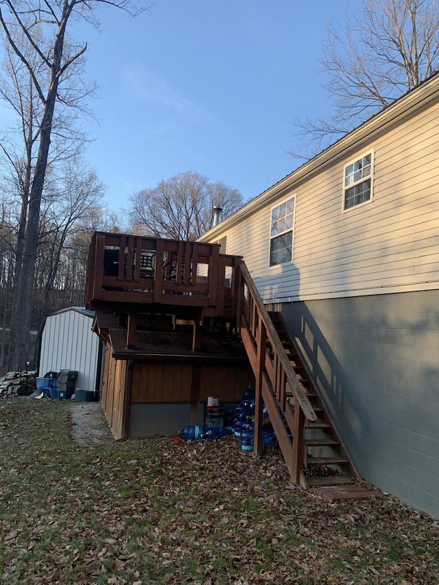 back of house featuring a deck and stairs