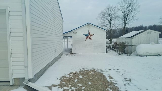 view of snow covered exterior with an outdoor structure