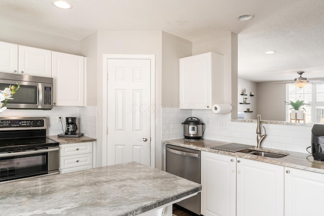 kitchen featuring sink, stainless steel appliances, and white cabinetry