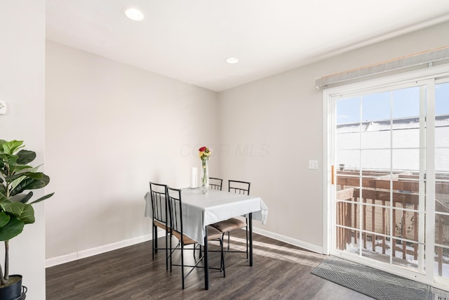 dining area with dark hardwood / wood-style flooring