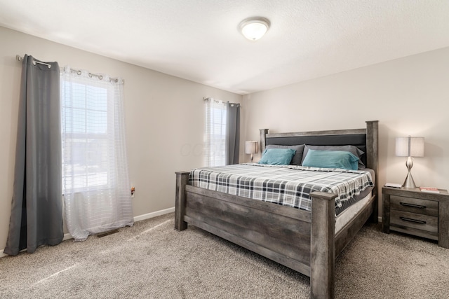 bedroom featuring carpet and a textured ceiling