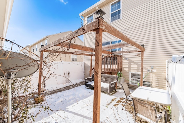 snow covered patio with a pergola