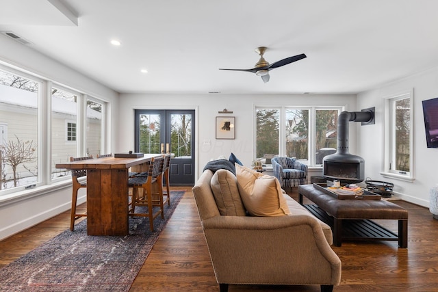 living room featuring french doors, dark hardwood / wood-style flooring, ceiling fan, and a healthy amount of sunlight