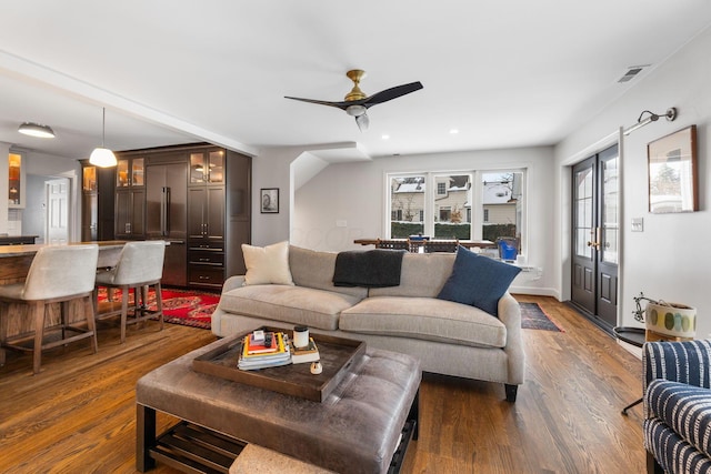 living room with ceiling fan and dark hardwood / wood-style floors