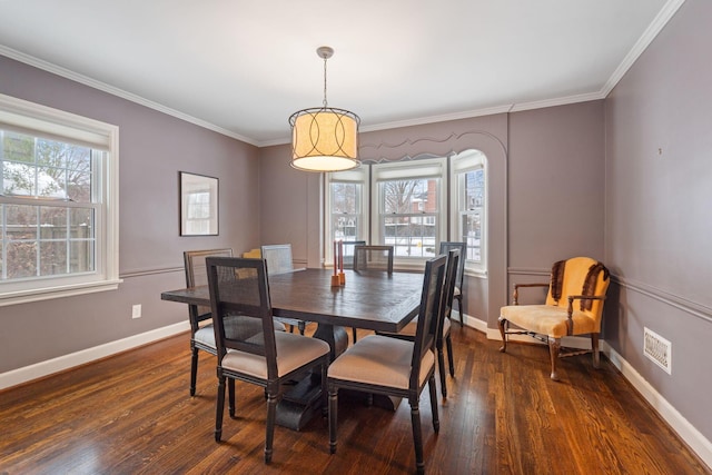 dining room featuring ornamental molding and dark wood-type flooring