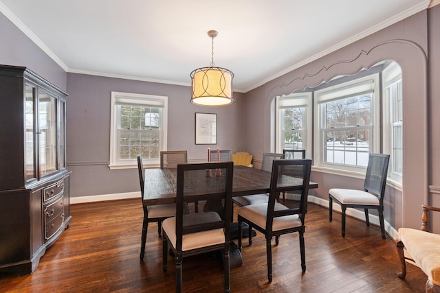 dining space with ornamental molding and dark hardwood / wood-style flooring