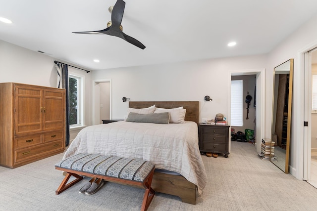 bedroom with ceiling fan and light carpet