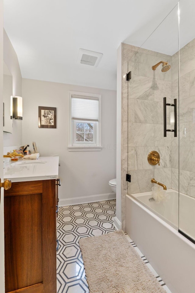 full bathroom featuring toilet, vanity, and enclosed tub / shower combo