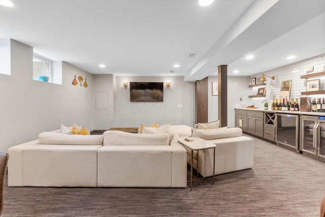 carpeted living room with beverage cooler and bar area