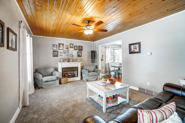 carpeted living room with ceiling fan and wood ceiling