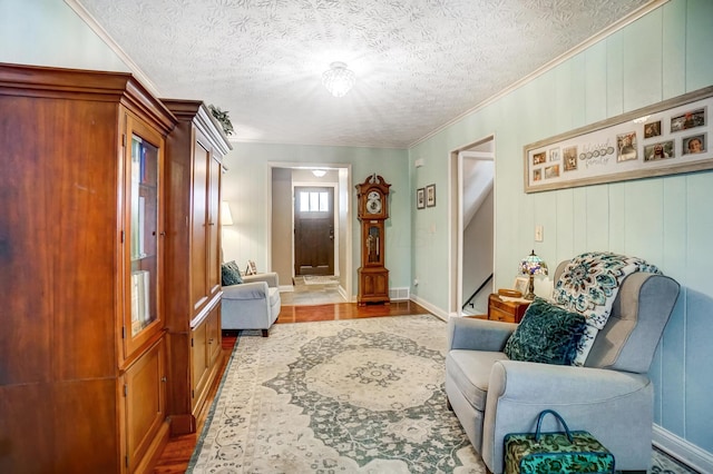 interior space with a textured ceiling and crown molding