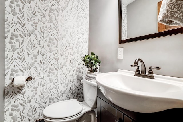 bathroom with toilet and vanity