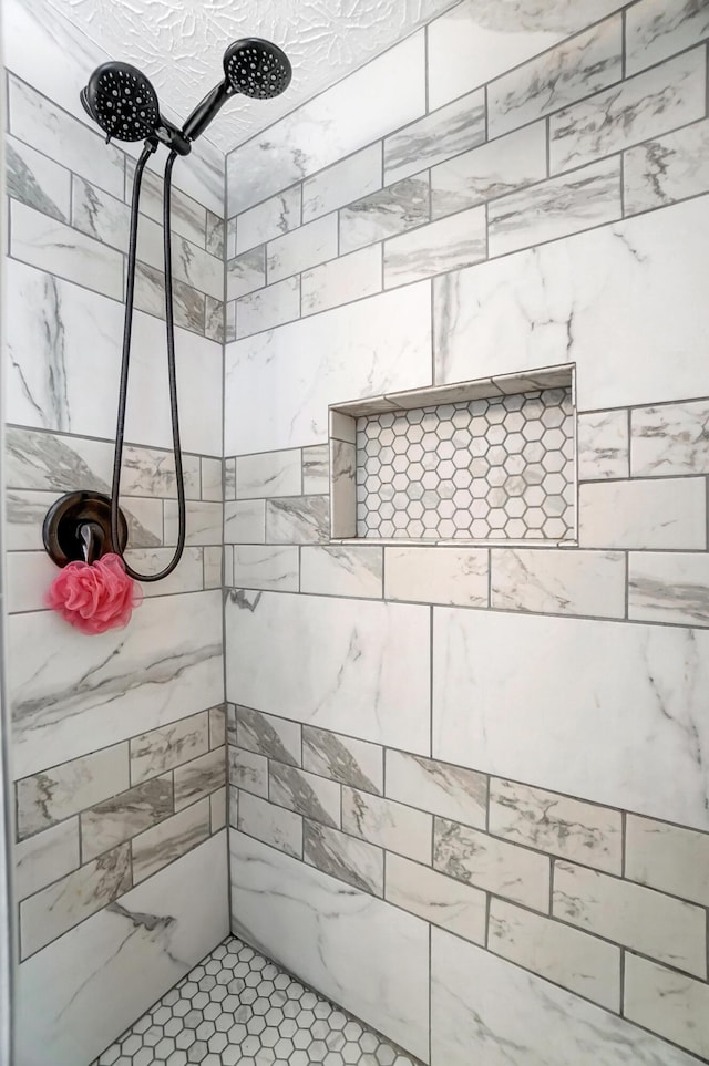 bathroom with a tile shower