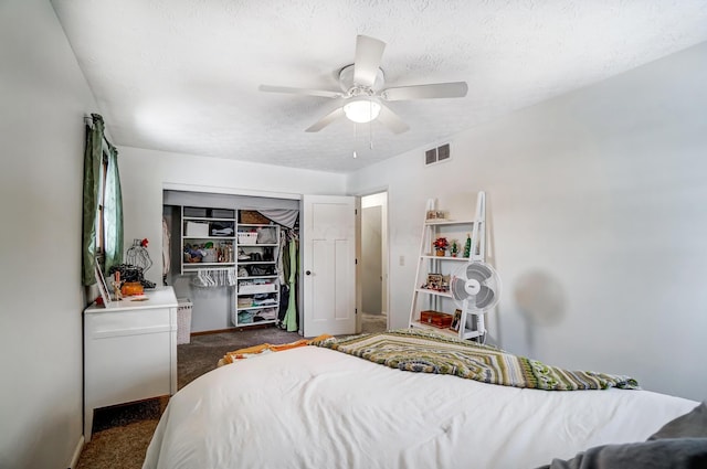 carpeted bedroom featuring a closet, ceiling fan, and a textured ceiling