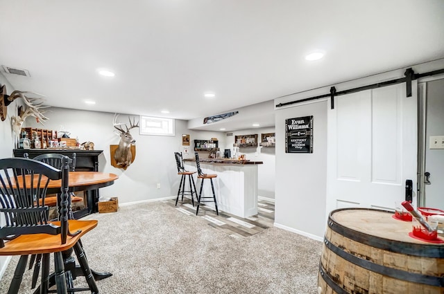 bar with a barn door and light carpet