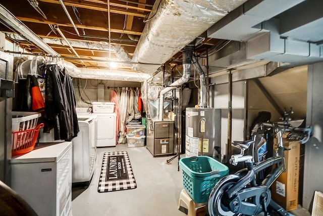 basement with washing machine and dryer, water heater, and heating unit