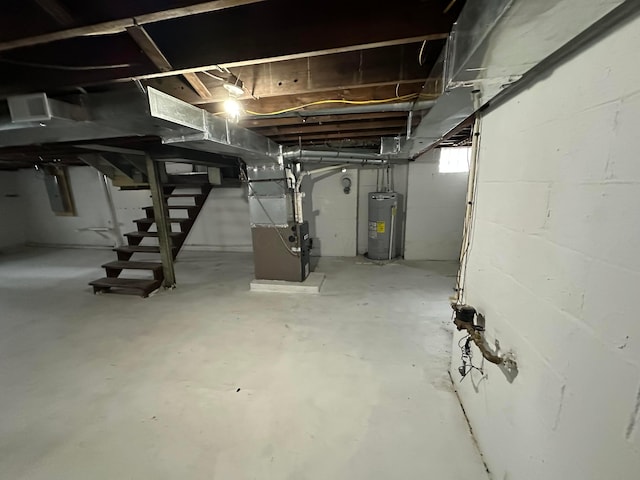 basement with electric water heater and heating unit