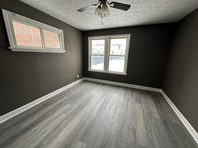 spare room featuring ceiling fan, a textured ceiling, and hardwood / wood-style flooring