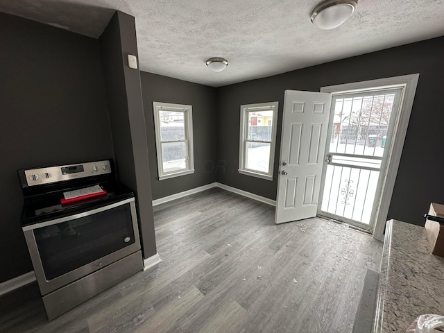 foyer entrance with a textured ceiling and hardwood / wood-style floors