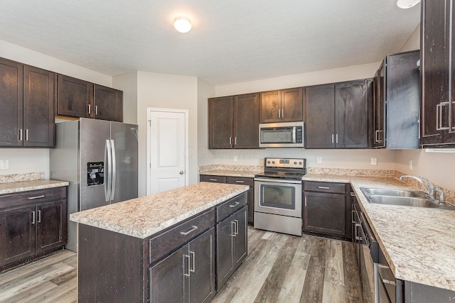 kitchen featuring stainless steel appliances, a center island, and dark brown cabinets