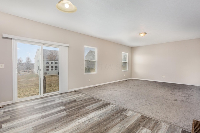 empty room with wood finished floors and baseboards