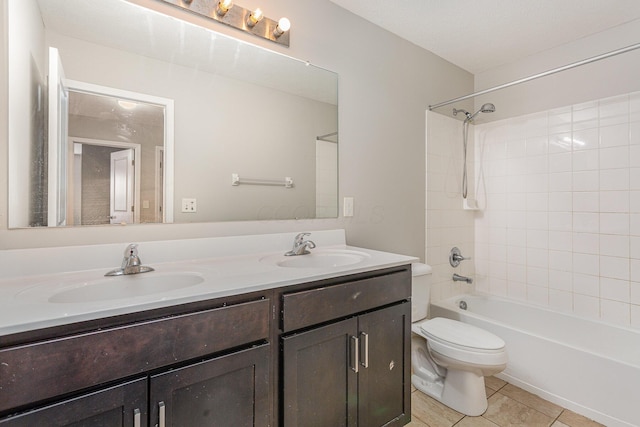 full bath featuring double vanity, tile patterned flooring, a sink, and toilet