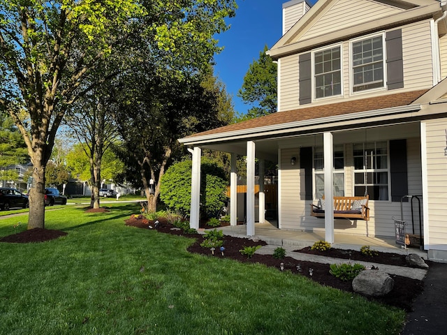 exterior space featuring a front lawn and a porch