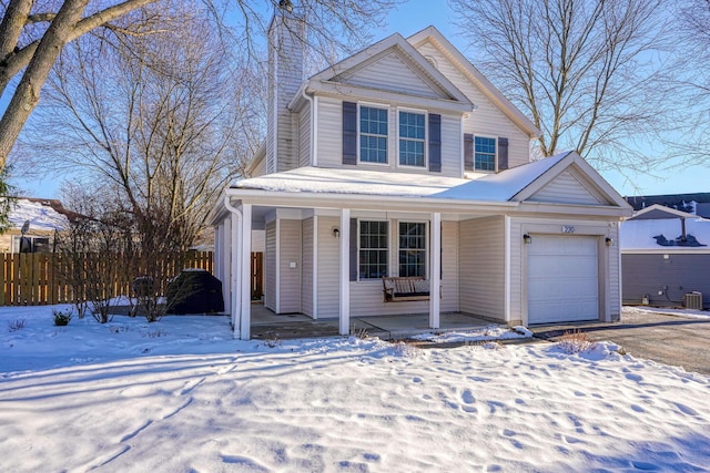 view of property with a garage and a porch