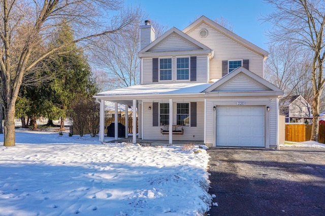 view of front of property featuring covered porch and a garage