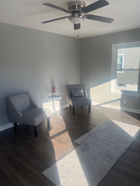 sitting room featuring ceiling fan and dark hardwood / wood-style floors