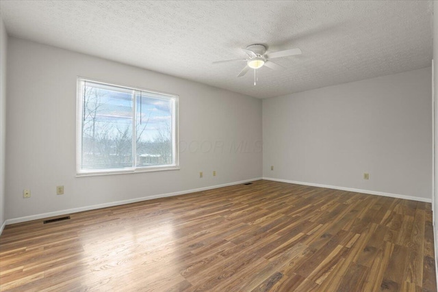 unfurnished room featuring ceiling fan, dark hardwood / wood-style flooring, and a textured ceiling