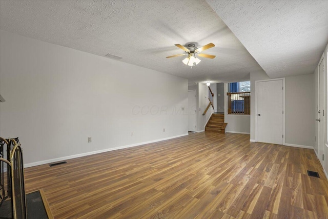 unfurnished living room with hardwood / wood-style flooring, a textured ceiling, and ceiling fan