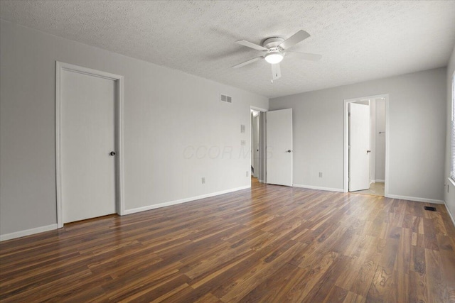 unfurnished bedroom featuring ceiling fan, dark hardwood / wood-style flooring, and a textured ceiling