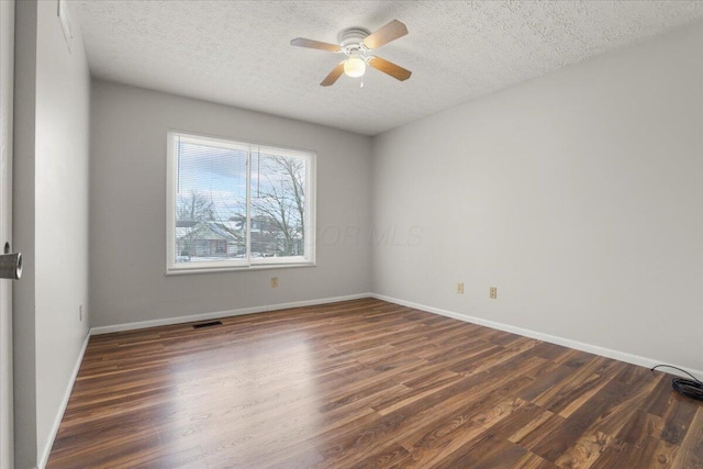 empty room featuring a textured ceiling, ceiling fan, and dark hardwood / wood-style flooring