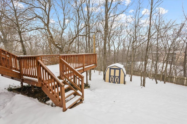 snow covered deck featuring a storage unit